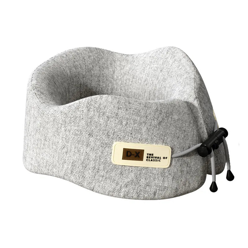 Light gray U-shaped travel pillow with memory foam, designed for premium neck and shoulder support, complete with a sleek carrying pouch.