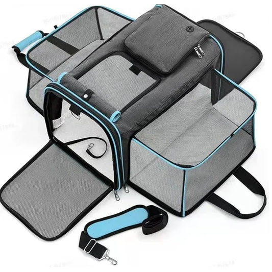 A fully expanded pet carrier showcasing the additional comfort zones, with black and gray fabric and teal piping. The carrier is displayed open, highlighting its spacious interior.