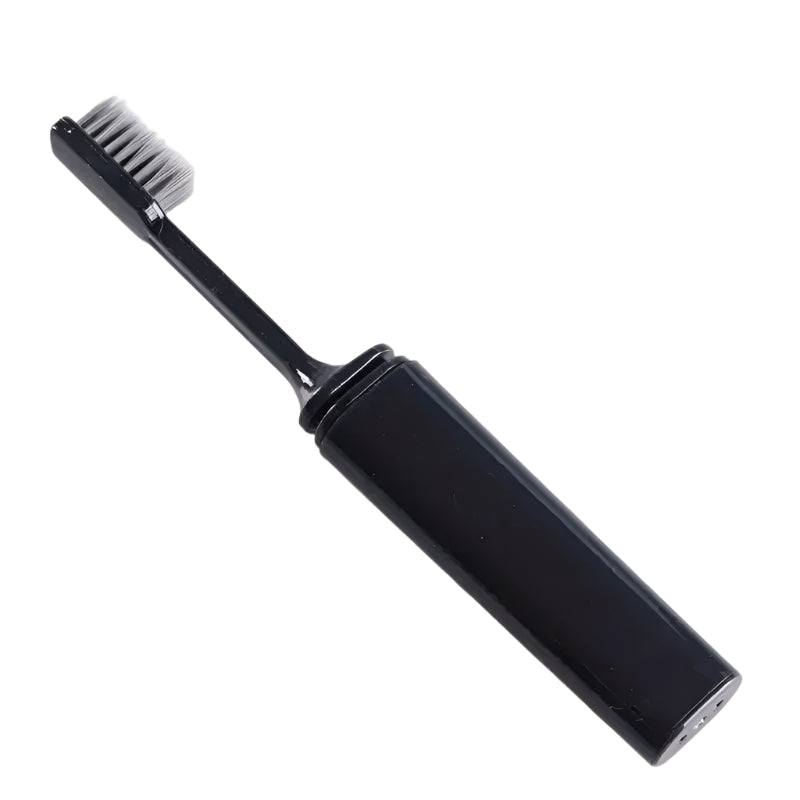 A black folding toothbrush in its fully extended position, showcasing its sleek design with charcoal-infused bristles for deep cleaning.