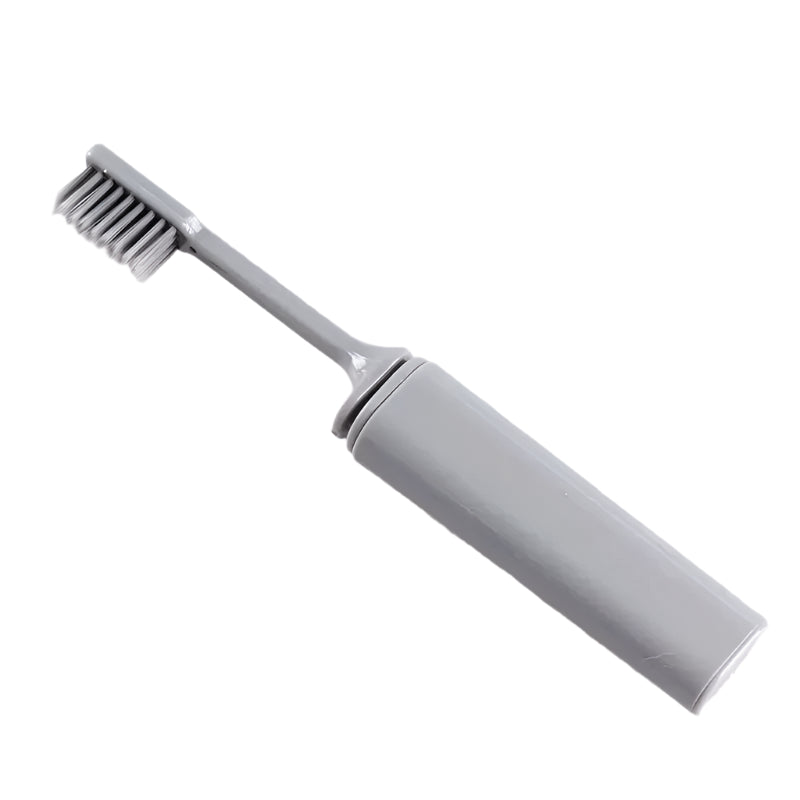 A silver folding toothbrush fully extended, emphasizing its lightweight and durable construction with charcoal-infused bristles.