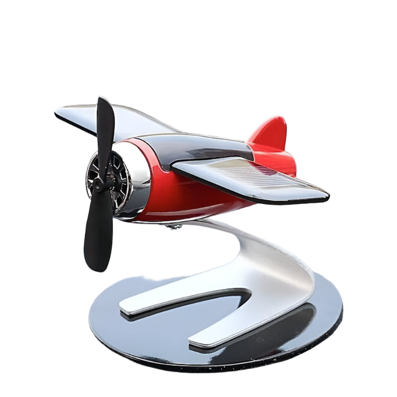 Side view of a solar-powered airplane ornament with a silver base and stationary propeller, emphasizing its modern design and intricate craftsmanship.